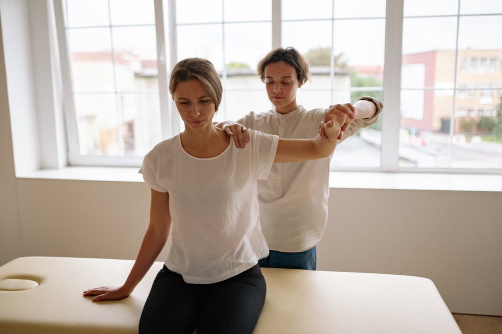 Physical therapist providing hands-on treatment during an in-clinic session